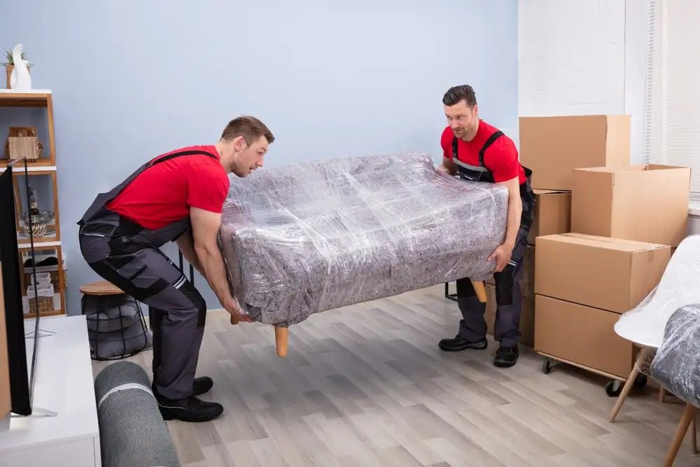 Professional movers carefully loading furniture into a moving truck for a local move in Daytona Beach, FL.